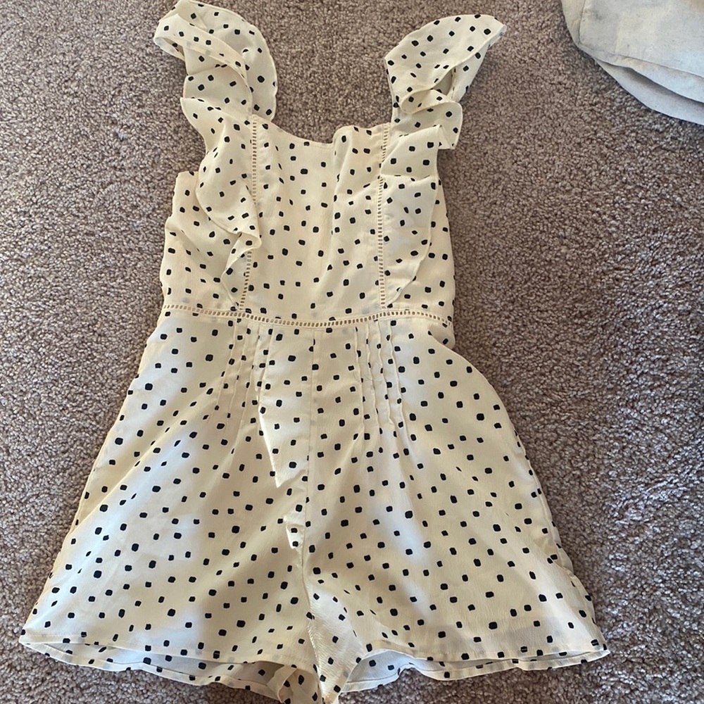 Cream and Black polka dot  romper with some ruffles in the front